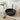 Matte black round ceramic vessel sink basin with central drain opening on countertop