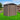 Metal storage shed with apex roof, double doors, and ventilation vents along the top
