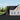 Black fish-scale asphalt shingles covering a pitched roof section