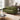 Green corduroy 2-seat sofa with rounded arms, two seat cushions, and dark wood legs