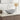 Light grey round ceramic countertop basin with chrome faucet and pop-up drain