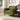 Green corduroy accent armchair with round arm details and wooden legs
