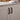 Matte black sliding door pull handles mounted on a white cabinet panel