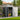 Grey metal garden storage shed with apex roof, double doors, and vents