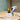 Paint sprayer gun with 1200ml container on stand, white body and yellow control panel