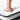 White quilted king hybrid mattress with a foot pressing into the surface