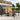 Adjustable aluminium pergola with light gray waterproof canopy and black posts.