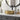 Gold ceramic round vessel sink with white basin and tall modern faucet