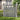 Gray wooden garden gate with vertical slats, sturdy corner posts, and horizontal cross rails