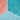 Water-resistant hexagon vinyl flooring corner with teal and coral surfaces and droplets