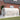 White walk-in greenhouse with arched PE cover and side ventilation window panels