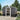 Anthracite metal garden storage shed with sliding door open, apex roof