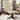 Beige recliner chair with ottoman, cushioned seat and back, dark swivel base